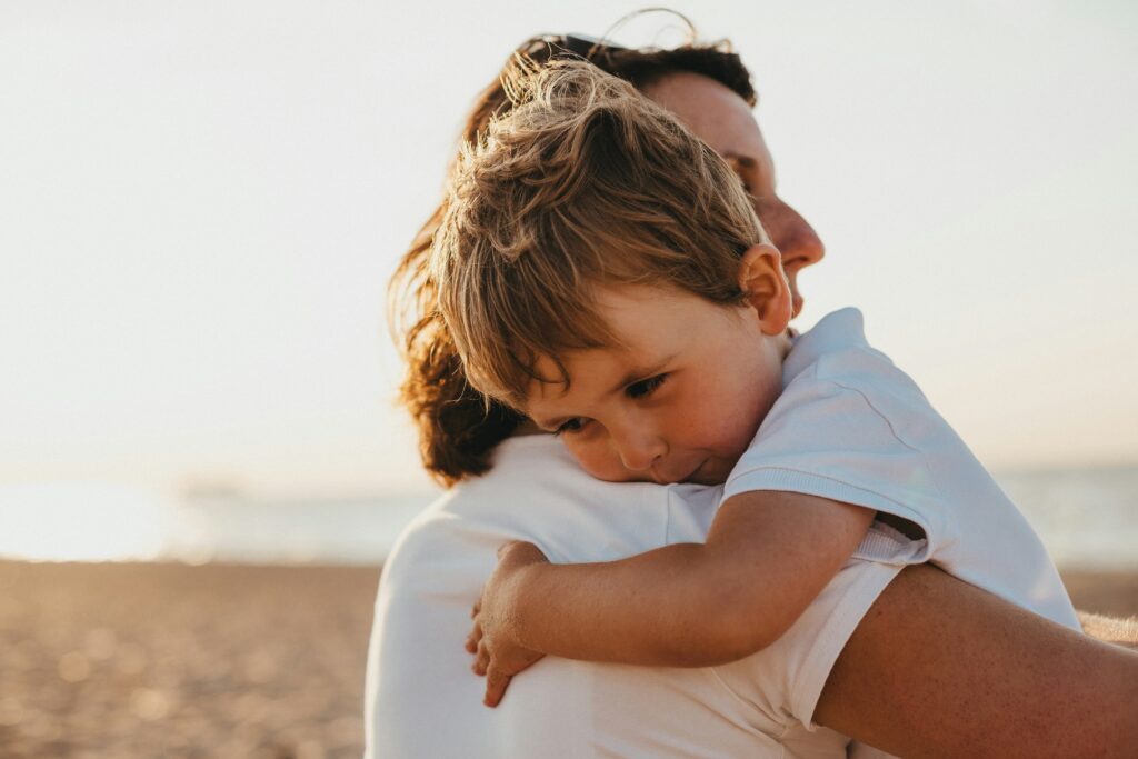 Women giving a hug to boy